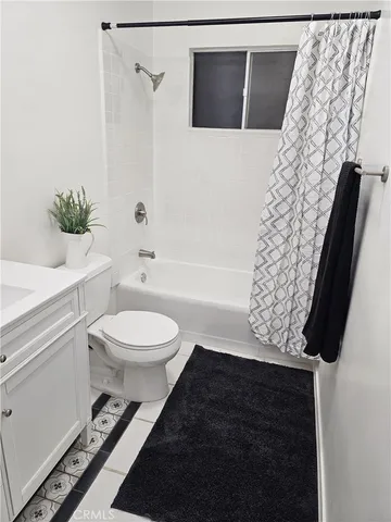 a bathroom with a toilet and a shower curtain