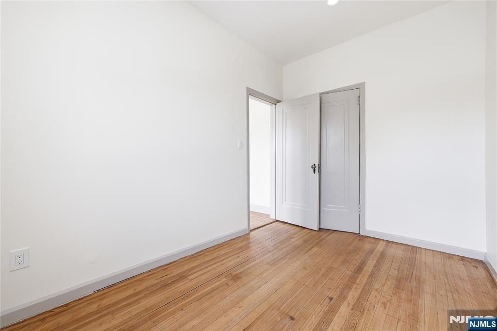 265 North 17th Street, Unit 2L Bloomfield, NJ 07003 - Photo 3 of 9 a view of an empty room with wooden floor