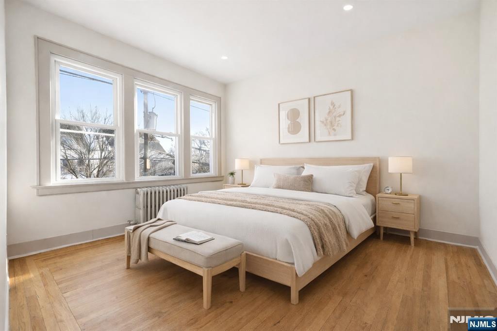 265 North 17th Street, Unit 2L Bloomfield, NJ 07003 - Photo 4 of 9 a bedroom with a bed and a large window