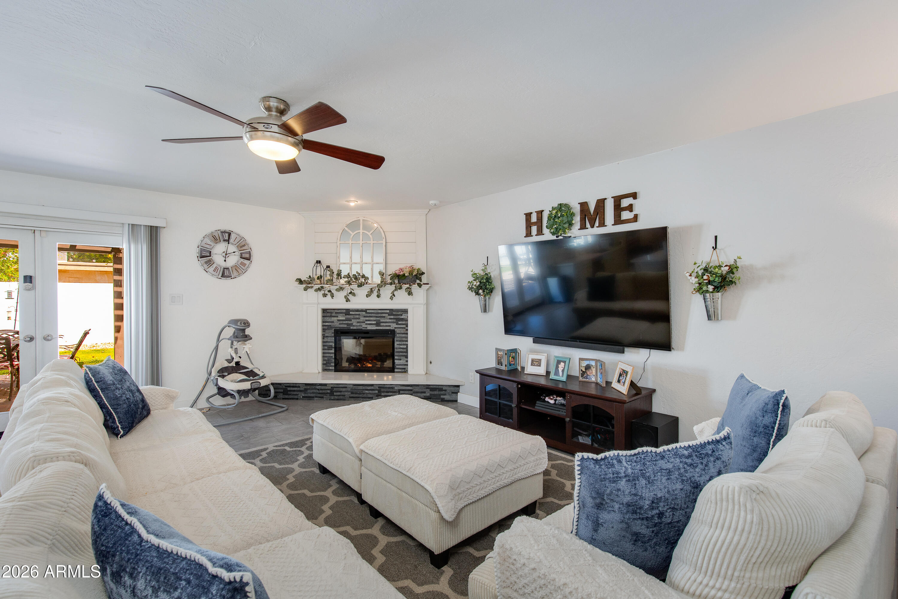 8219 North 3rd Avenue Phoenix, AZ 85021 - Photo 23 of 52 a living room with furniture a flat screen tv and a fireplace