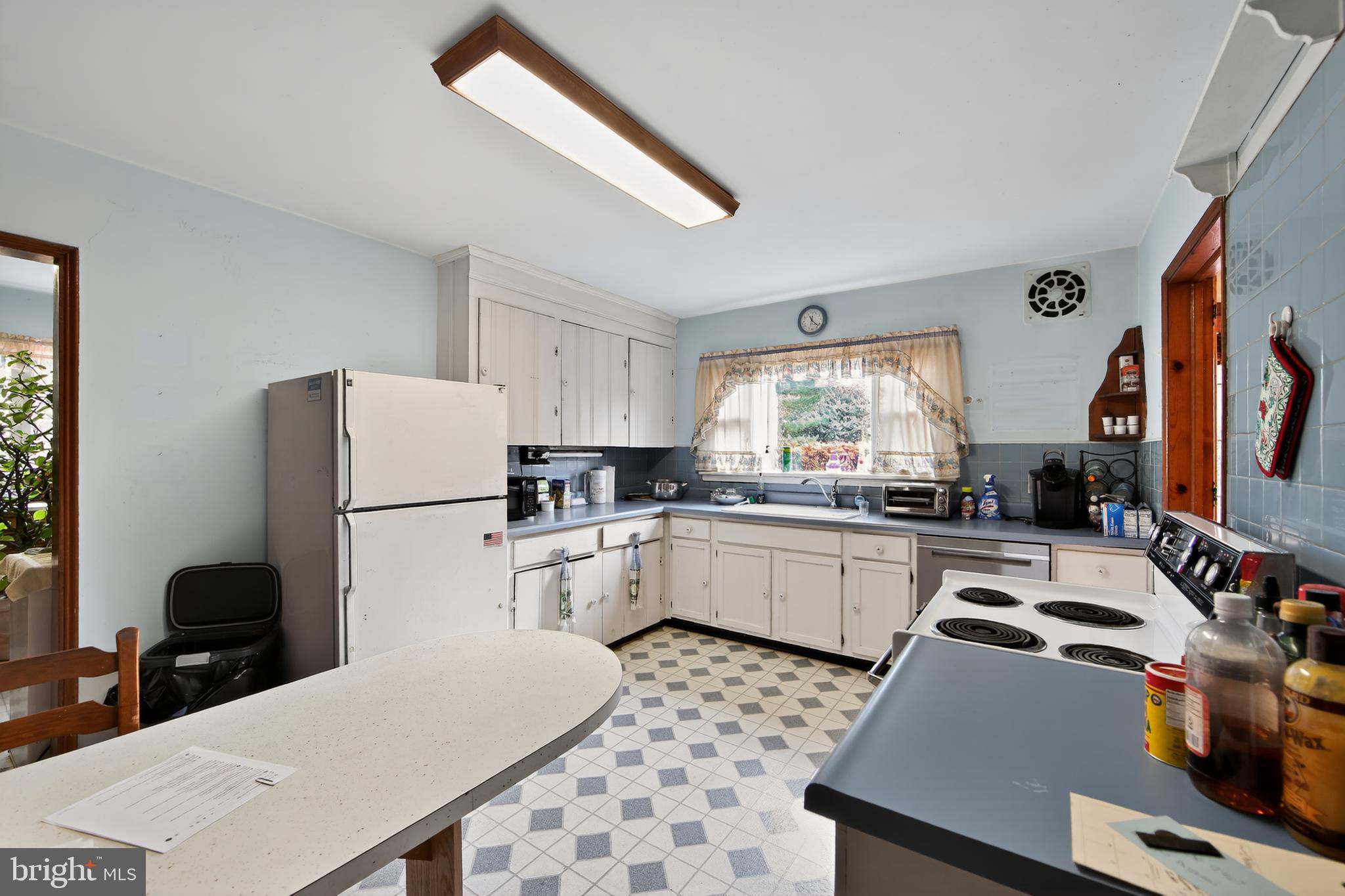 31 Barren Road Newtown Square, PA 19073 - Photo 11 of 27 a kitchen with a appliances a refrigerator and a stove top oven