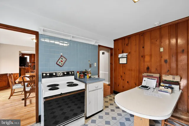 a room with furniture a mirror and a wooden floor