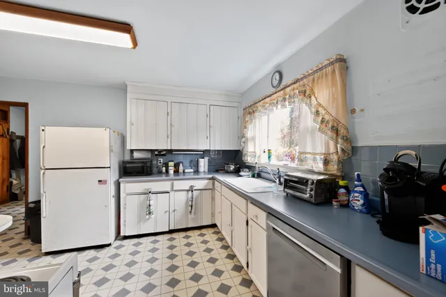 a kitchen with a white cabinets and white appliances