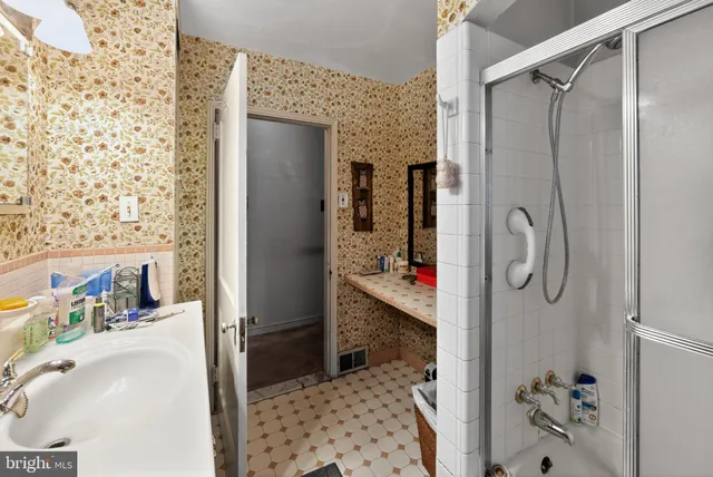 a bathroom with a shower and a sink