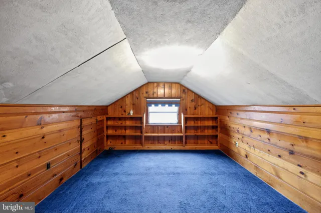 a view of room with stairs and a dresser