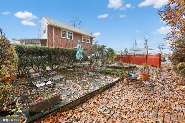 a front view of a house with yard and trees