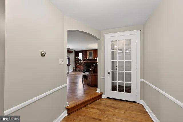 a view of a room with wooden floor and a window