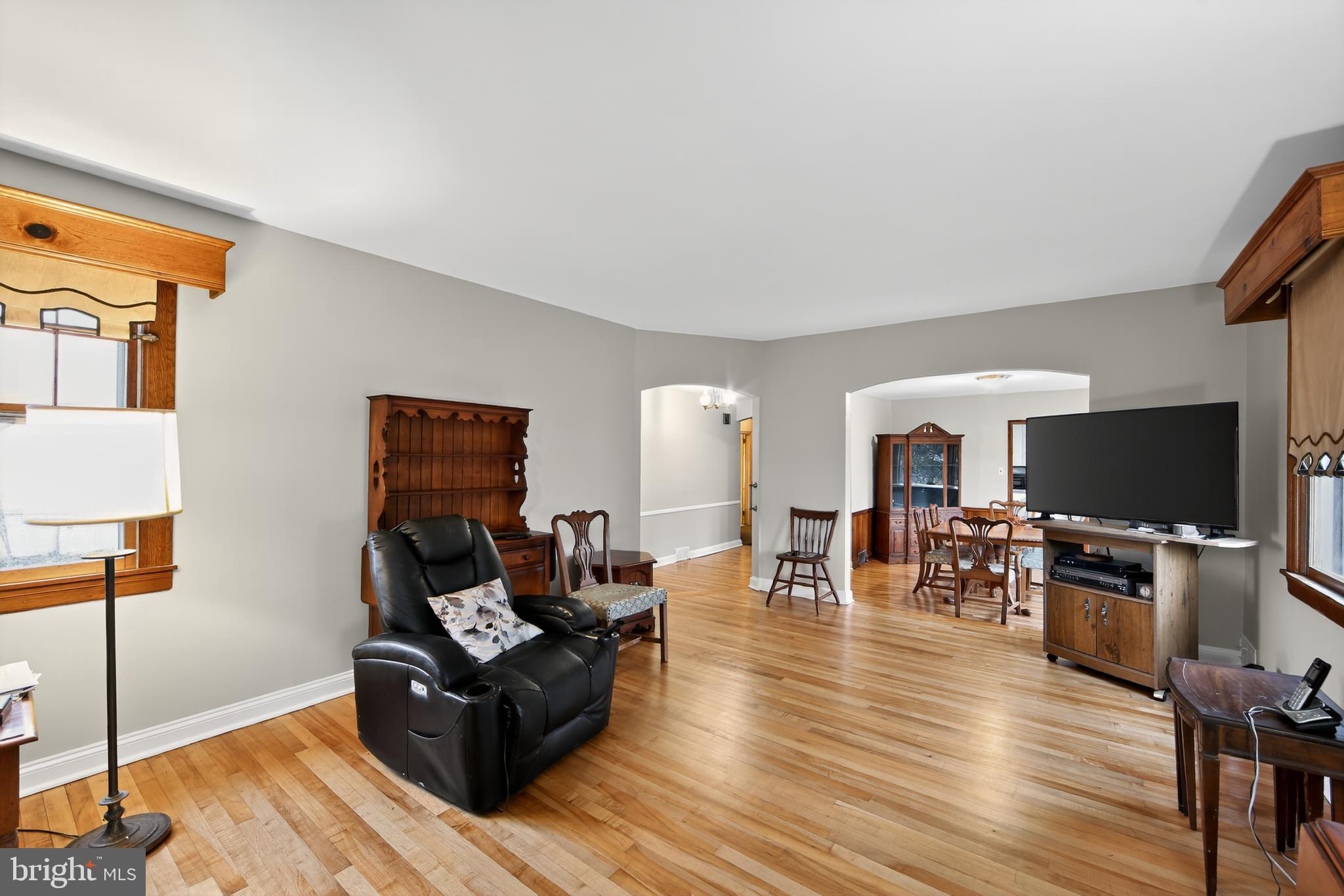 31 Barren Road Newtown Square, PA 19073 - Photo 8 of 27 a living room with furniture a flat screen tv and a table