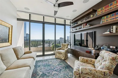 a living room with furniture or couch and a floor to ceiling window