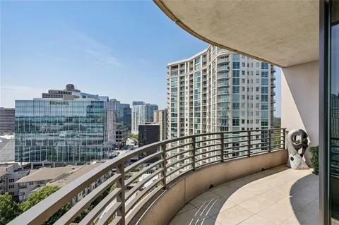 a bedroom with a large bed and a balcony view
