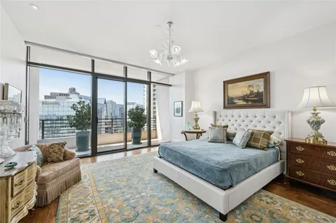 a bedroom with a bed and a chandelier