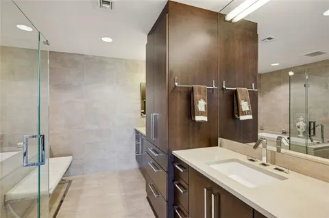 a spacious bathroom with a shower sink and mirror
