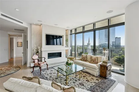 a living room with furniture fireplace and a table