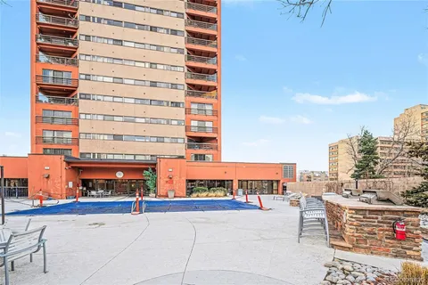 a view of a patio with dining table and chairs and potted plants