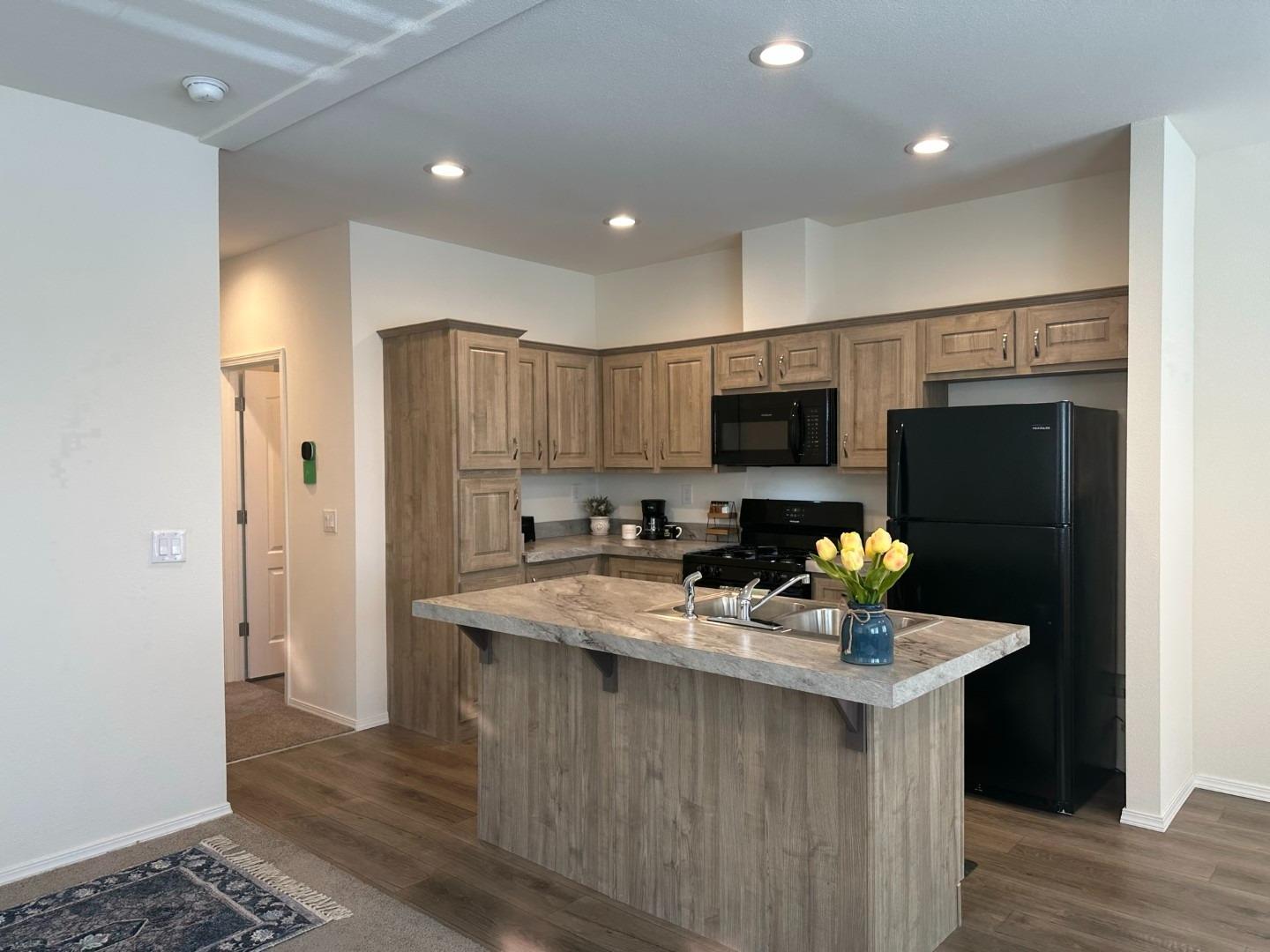 5812 Cedars Road, Unit 3 Redding, CA 96001 - Photo 2 of 14 a kitchen with stainless steel appliances a refrigerator sink and microwave