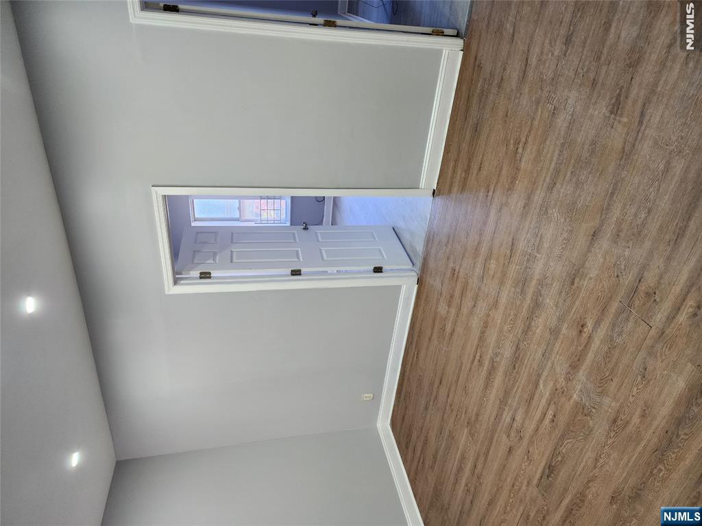 347 Avon Avenue Newark, NJ 07108 - Photo 2 of 4 a view of an empty room with wooden floor