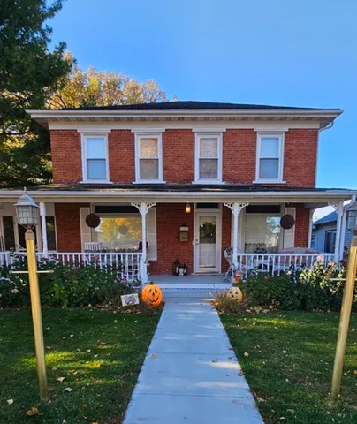 a front view of a residential apartment building with a yard