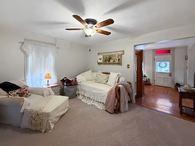 a bedroom with two beds and painting on the wall