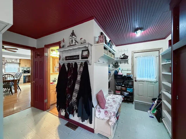 a dining room with furniture entryway and wooden floor