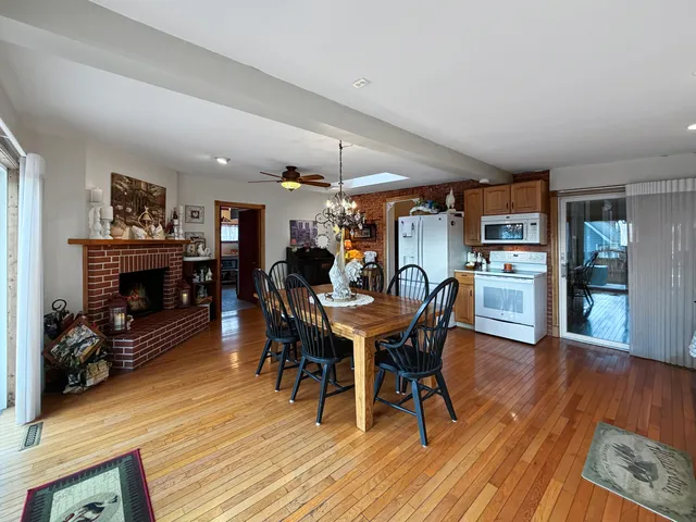 a view of a dining room with furniture wooden floor and chandelier