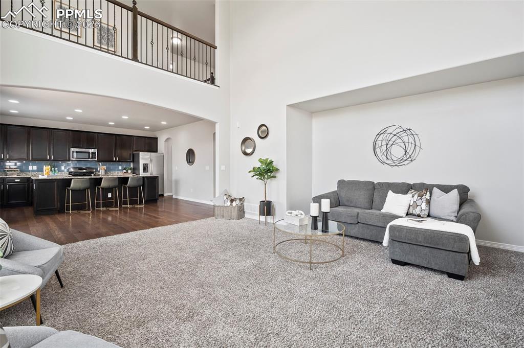 13232 Park Meadows Drive Peyton, CO 80831 - Photo 14 of 23 a living room with furniture and wooden floor
