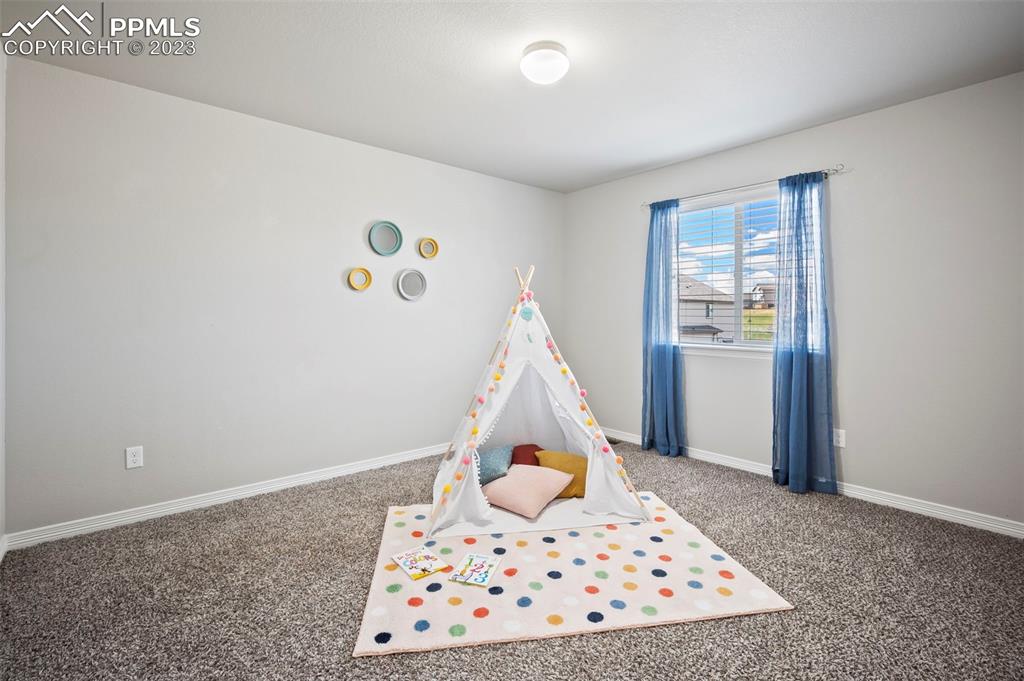 13232 Park Meadows Drive Peyton, CO 80831 - Photo 20 of 23 a bedroom with a bed and a window in it