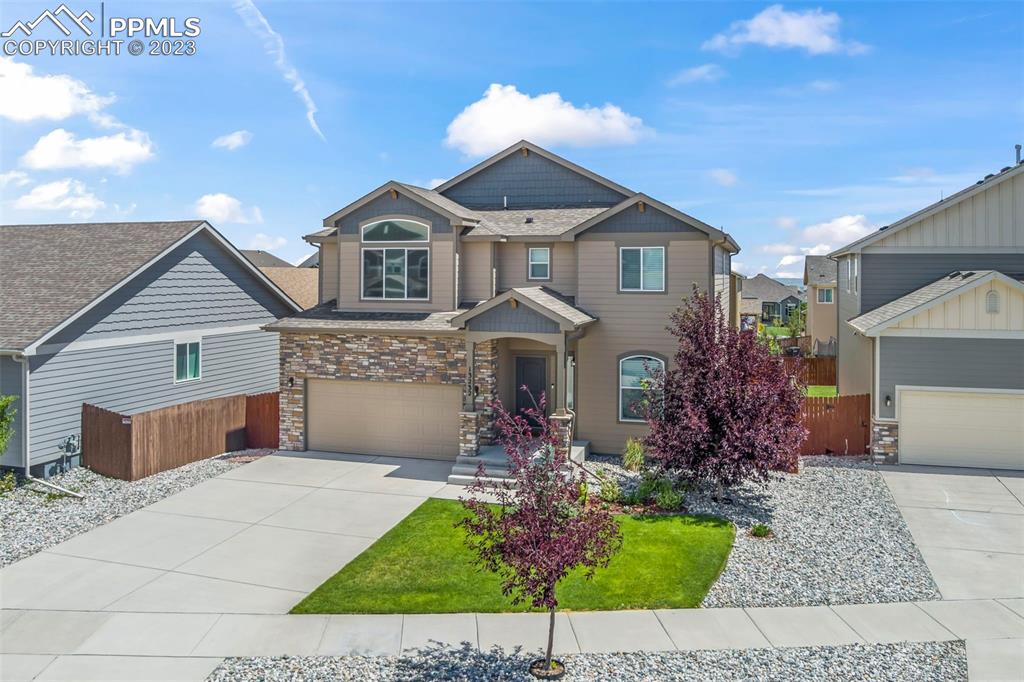 13232 Park Meadows Drive Peyton, CO 80831 - Photo 2 of 23 a front view of a house with a garden