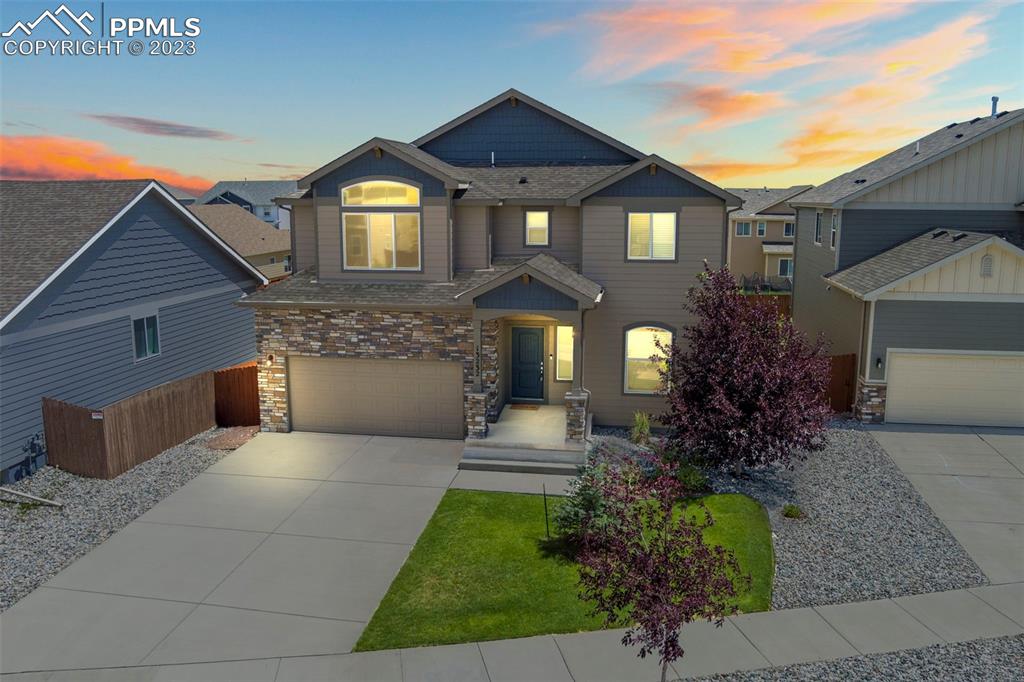 13232 Park Meadows Drive Peyton, CO 80831 - Photo 4 of 23 a front view of a house with garden