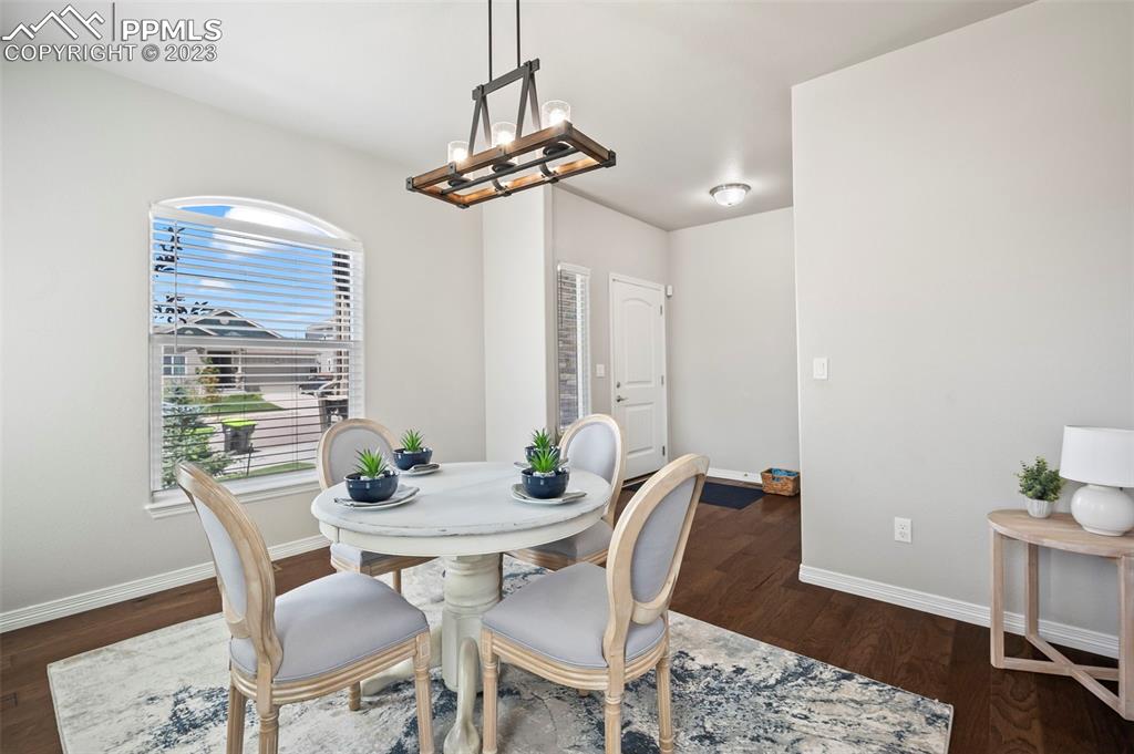 13232 Park Meadows Drive Peyton, CO 80831 - Photo 6 of 23 a view of a dining room with furniture window and wooden floor