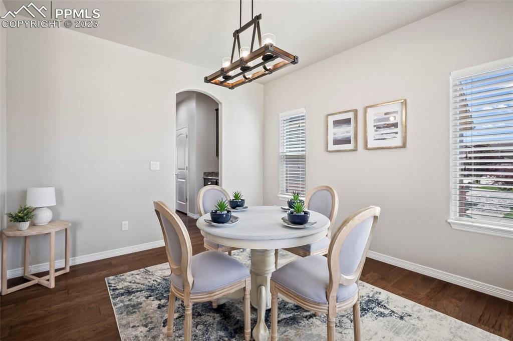 13232 Park Meadows Drive Peyton, CO 80831 - Photo 7 of 23 a view of a dining room with furniture and wooden floor