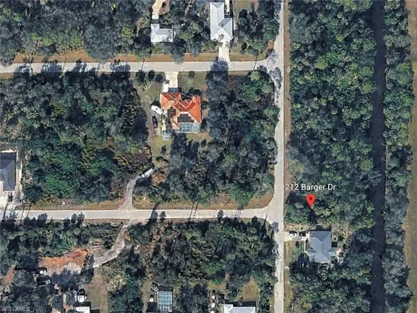 an aerial view of a house with a yard and garden