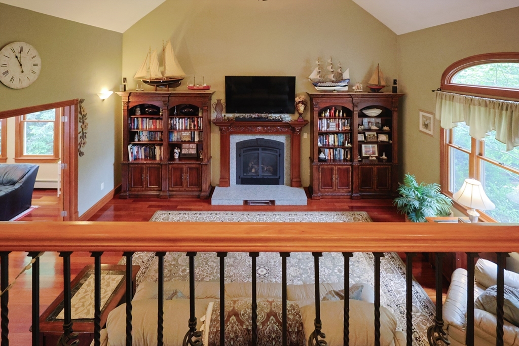 70 Azalea Way Hanson, MA 02341 - Photo 21 of 42 a living room with furniture a flat screen tv and a fireplace