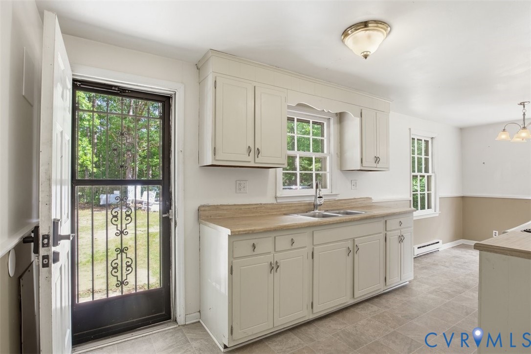 14527 Arwood Road Disputanta, VA 23842 - Photo 9 of 20 a kitchen with a sink window and cabinets