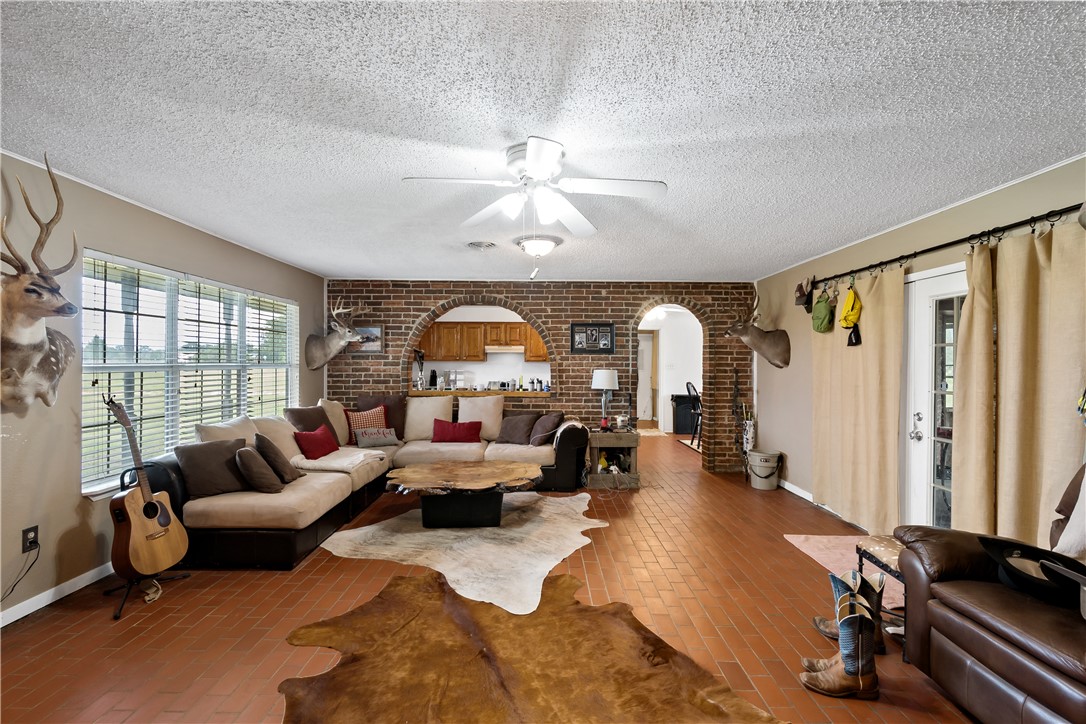 8166 Riley Road Bryan, TX 77808 - Photo 16 of 47 a living room with furniture gym equipment and a large window