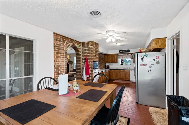 a kitchen with stainless steel appliances granite countertop a refrigerator and sink