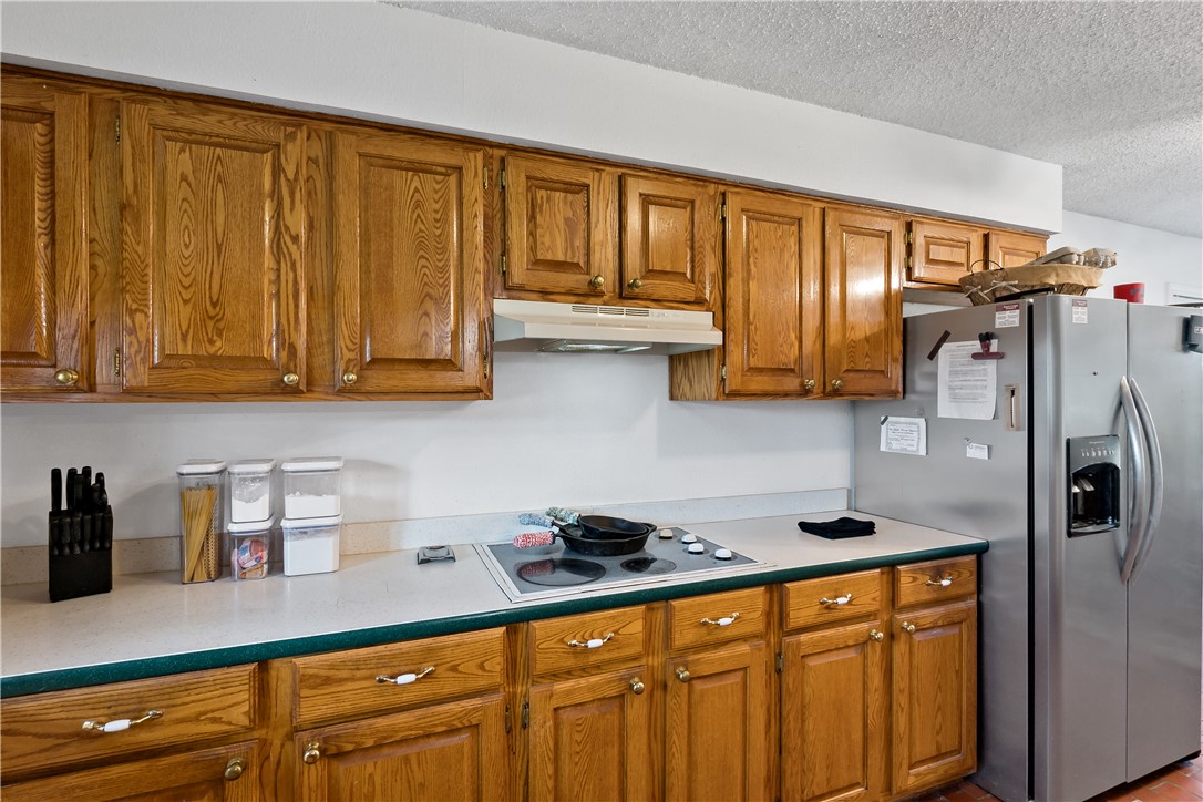 8166 Riley Road Bryan, TX 77808 - Photo 21 of 47 a kitchen with stainless steel appliances granite countertop a refrigerator and sink