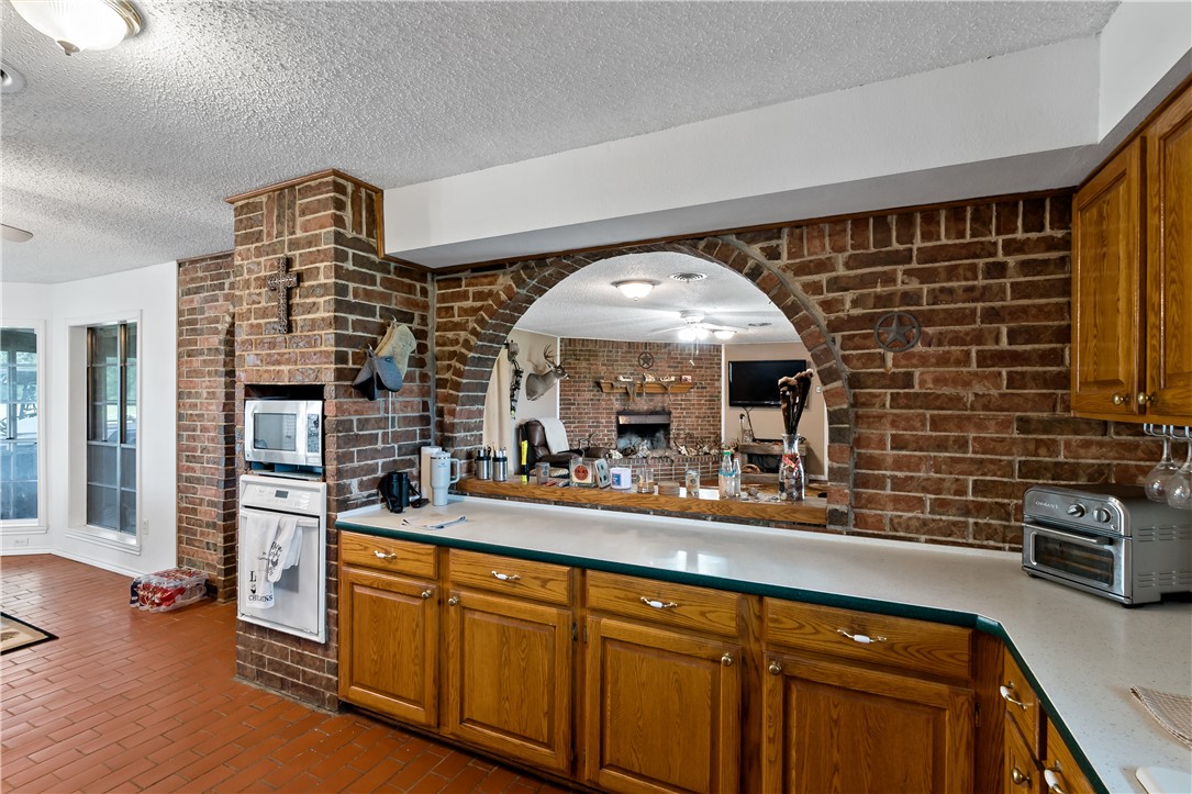 8166 Riley Road Bryan, TX 77808 - Photo 22 of 47 a kitchen with stainless steel appliances a sink cabinets and wooden floor