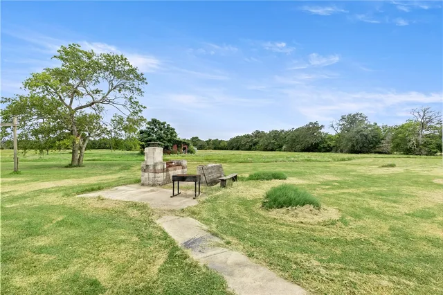 a view of a house with backyard and a garden