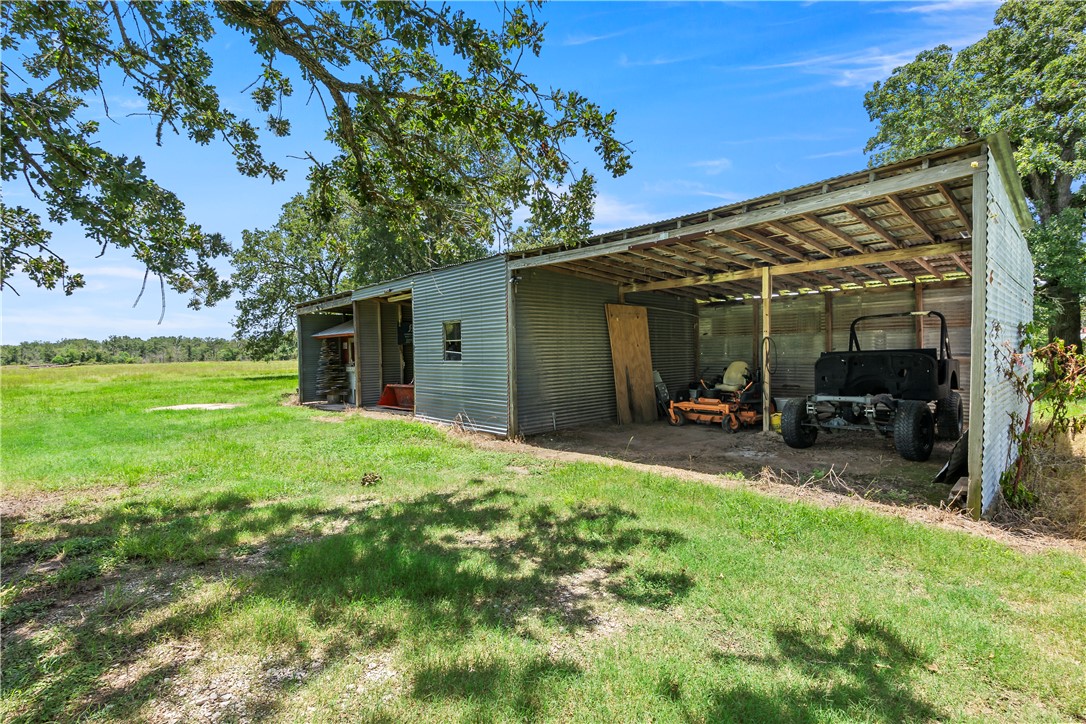 8166 Riley Road Bryan, TX 77808 - Photo 36 of 47 a view of a backyard with table and chairs and a large tree