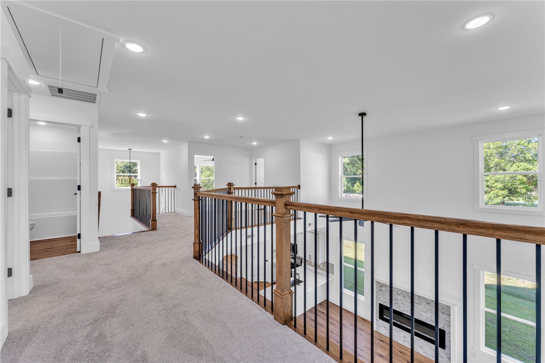 1723 Harris Bridge Road Anderson, SC 29621 - Photo 18 of 33 A spacious upper-level landing with elegant railing overlooks the bright main living area.