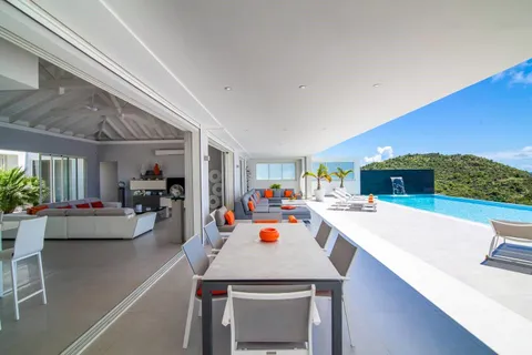 a view of a dining area with furniture and a chandelier