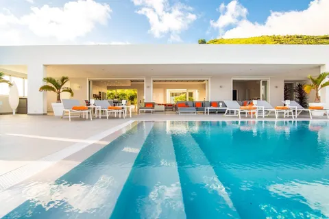 a view of a swimming pool and outdoor seating