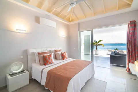 a bedroom with a bed and large window