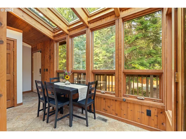 a view of a dining room with furniture large windows and wooden floor