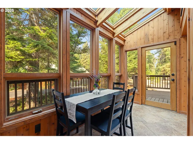 a dining room with furniture a chandelier and wooden floor