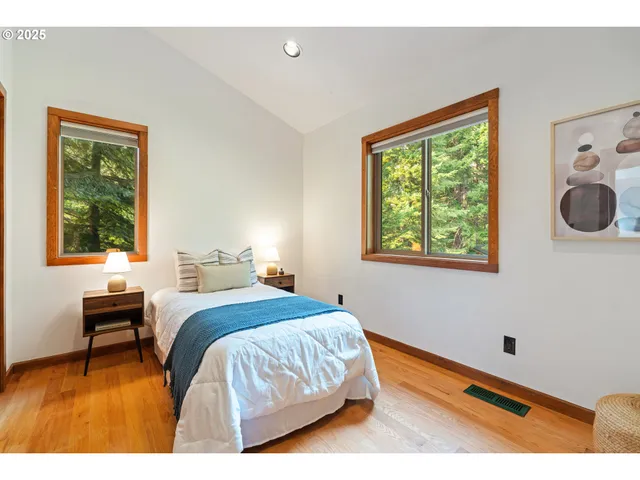 a bedroom with a bed and a table in it with window