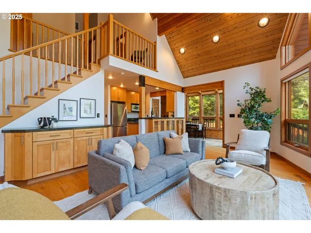 a living room with furniture a rug and a chandelier