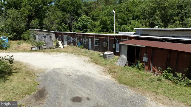 a view of house with backyard and sitting area
