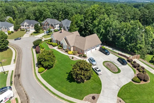 a front view of a house with a yard and potted plants