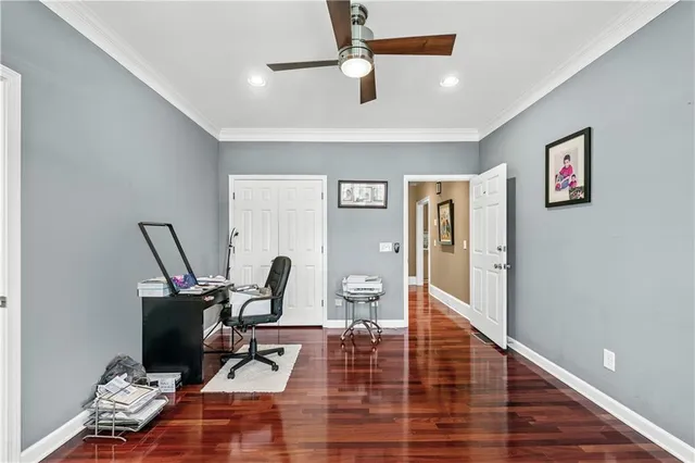 a spacious bedroom with a bed and wooden floor